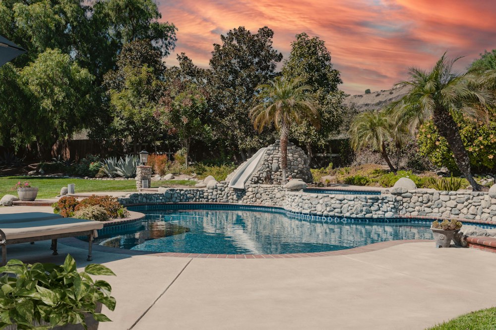 Pool deck with natural rock waterfall and desert planting